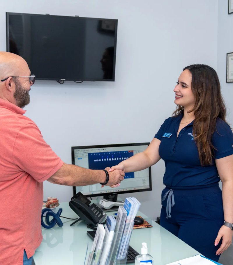 Paya Dental team greeting a patient