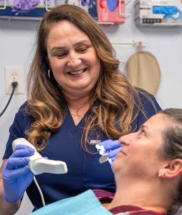 Hygienist caring for a smiling patient