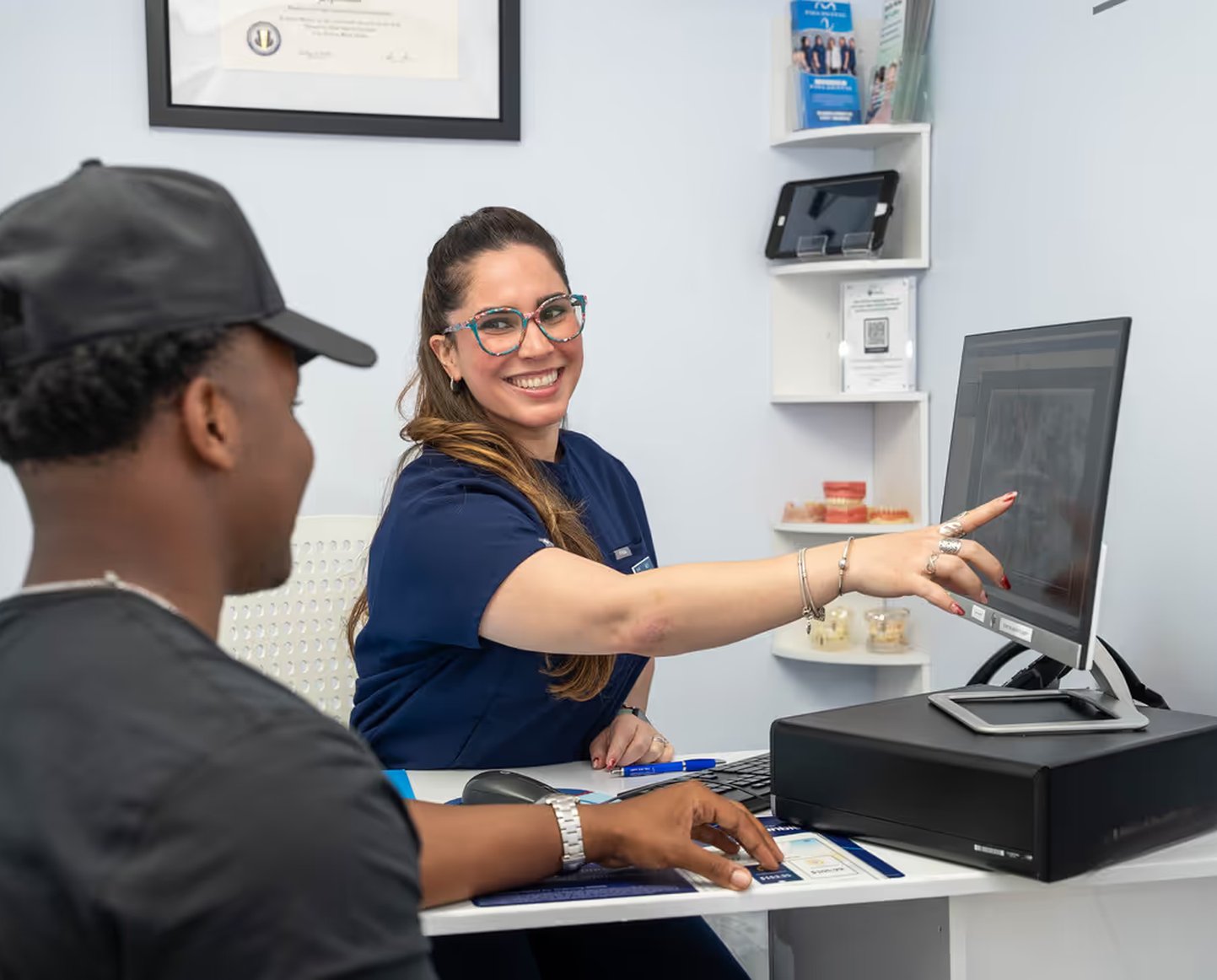 Team member showing a patient their treatment on screen