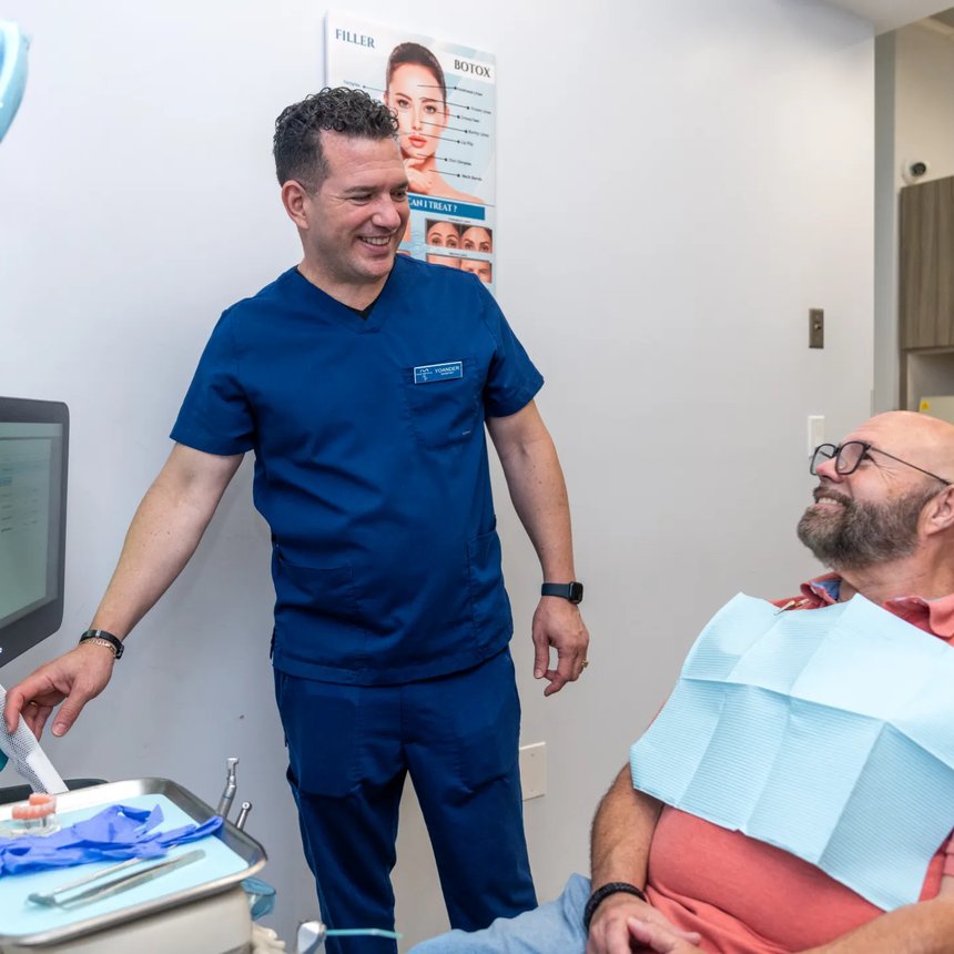 Paya Dental dentist with a smiling patient