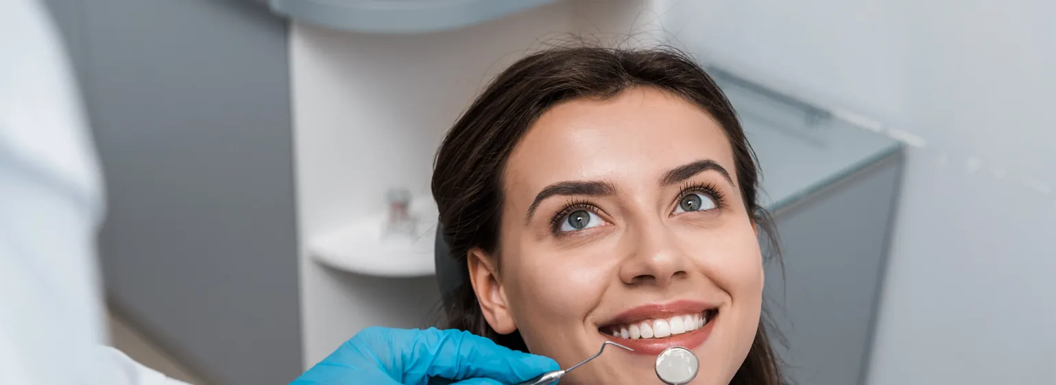 Smiling woman in the dental chair during a checkup