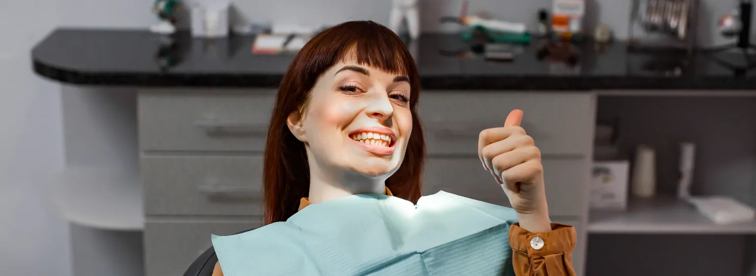 Happy patient giving a thumbs up after dental treatment