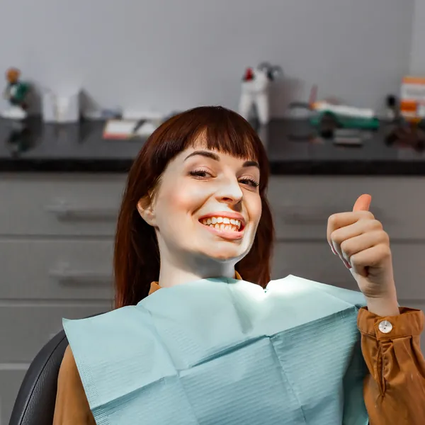 Happy patient giving a thumbs up after dental treatment