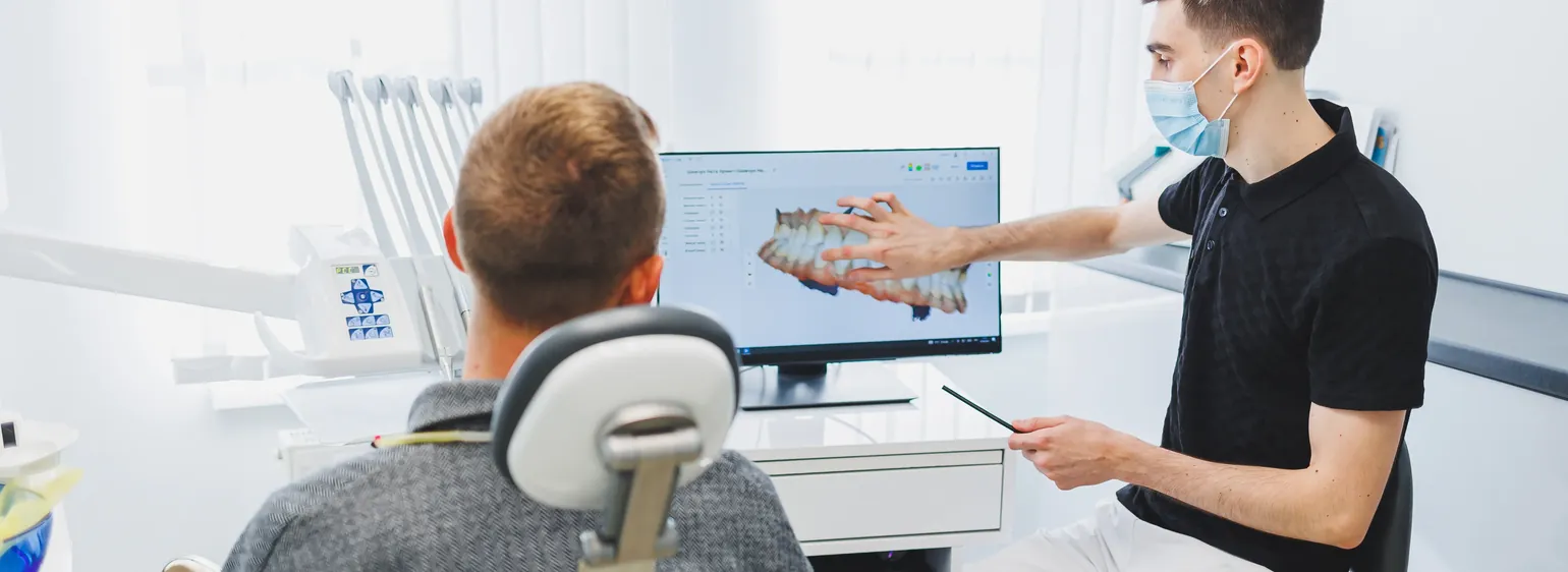 Dentist explaining a digital scan to a patient