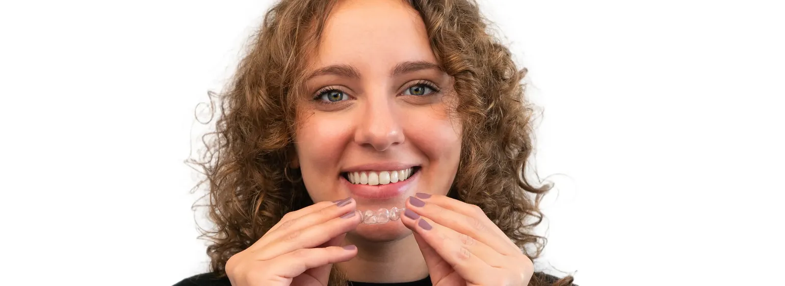 Woman placing a clear aligner