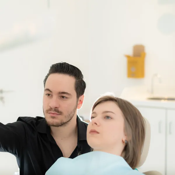 Dentist showing a dental x-ray to a young patient